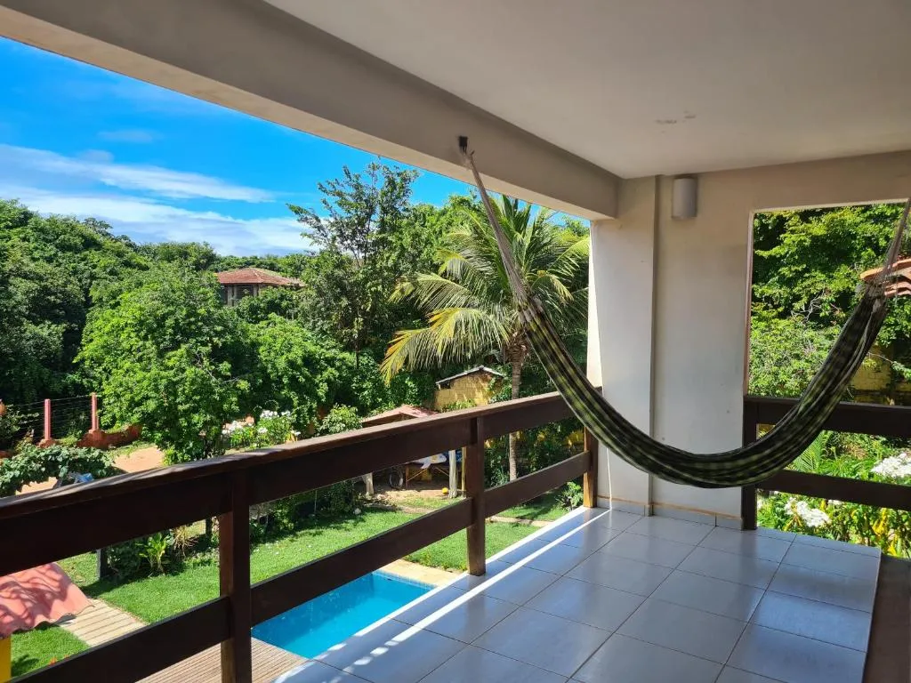 Dorm 4 balcony at Iduna Hostel with a hammock and pool view
