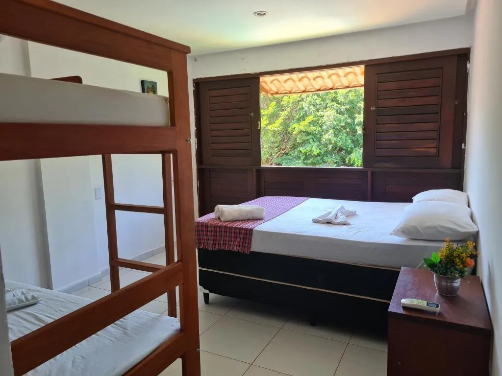 Suite 1 at Iduna Hostel with a double bed and wooden bunk bed