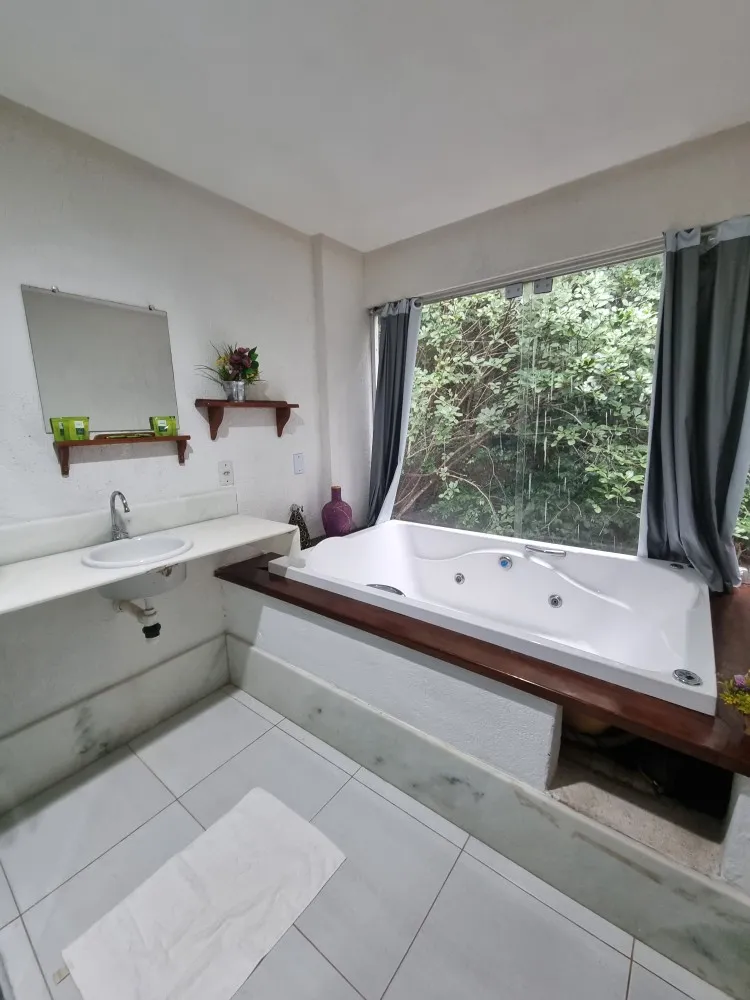 Hot tub in Suite 3 at Iduna Hostel facing a forest window